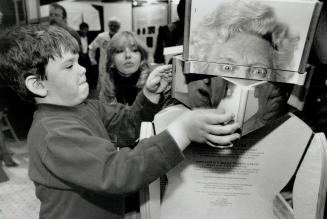 Changing face. Misha Rosolak, 4, plays with a display which allows the participant to rearrange photographs of facial features. It's part of the new s(...)