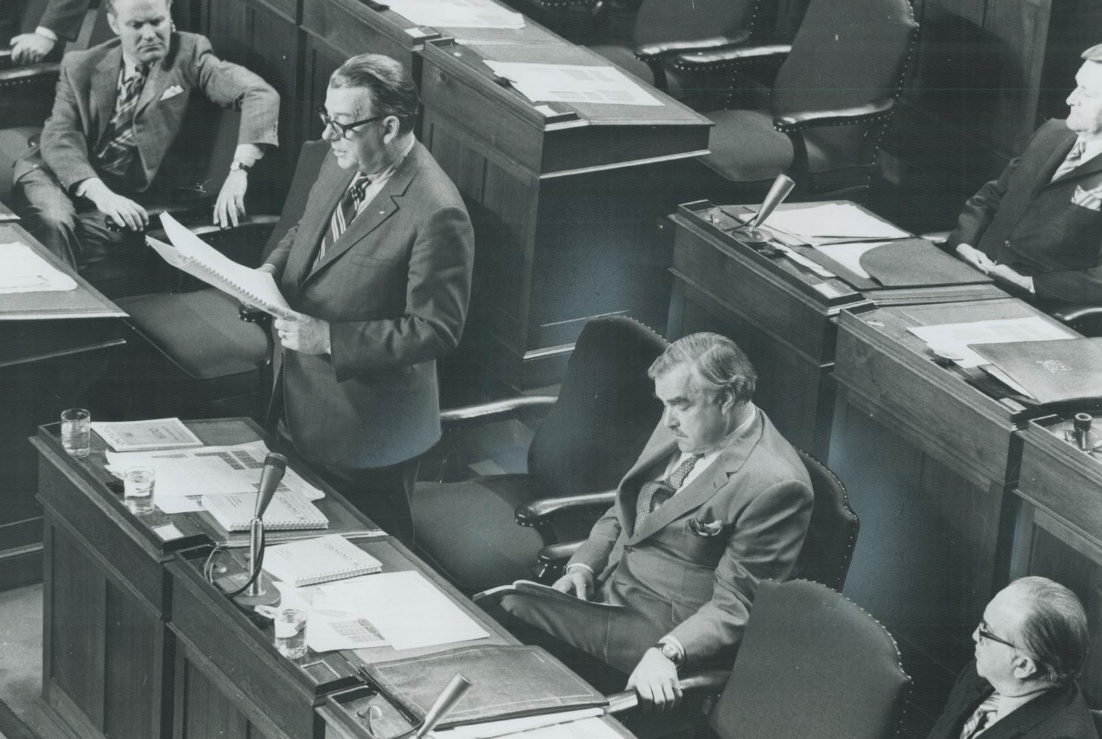 Delivering budget speech, Ontario Treasurer Charles MacNaughton stands at his desk on the floor of the Legislature yesterday outlining policies he say(...)