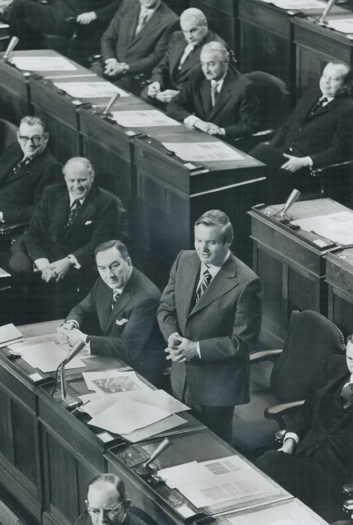 Premier William Davis speaks in the Legislature, after the Speech from the Throne was read yesterday, as Arthur Wishart, minister of financial affairs listens