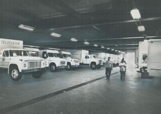 Telegram trucks stand ready to deliver a newspaper that, according to publisher john Bassett, is doomed to extinction