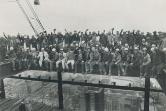 Centre puts 'Topping' on Gigantic 'Cake', Delighted workmen have something to cheer about as a milestone is reached at noon today at the Toronto-Domin(...)