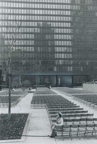 All alone before the party, Shelley Hailman, a Toronto-Dominion Centre hostess, sat to eat her lunch on one of the 2,000 folding chairs set out for gu(...)