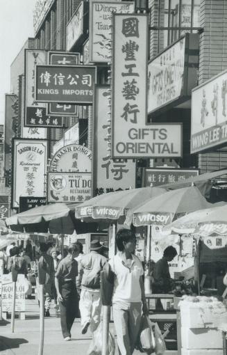 Busy street: Chinatown, above, was pinpointed in a recent investigation of a rash of pickpocketing that tipped police to the smuggling of illegal immigrants