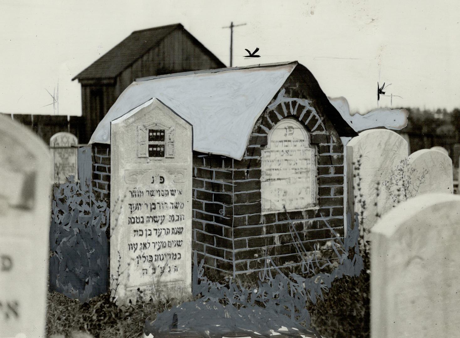 A tiny brick house with a stone inlay etched with Hebrew text