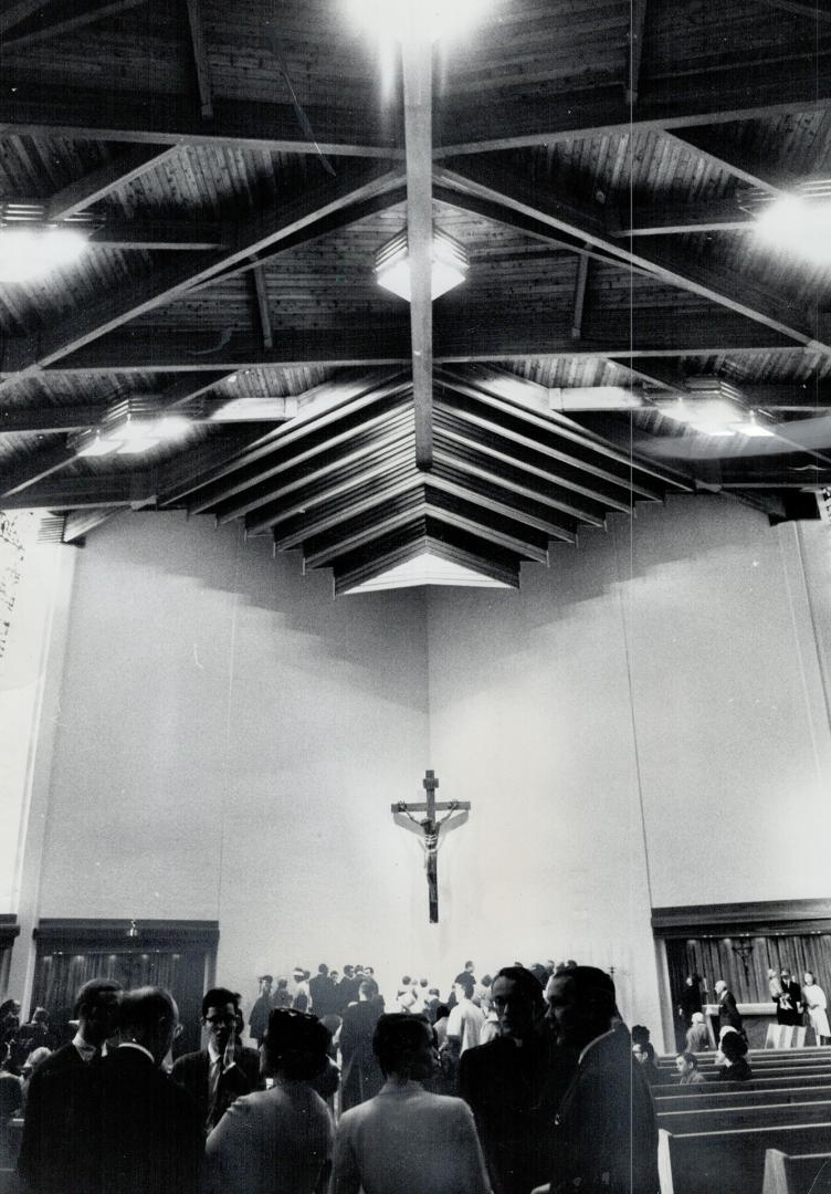 Wooden beam ceiling construction of the new college makes a particularly striking effect over the chapel altar