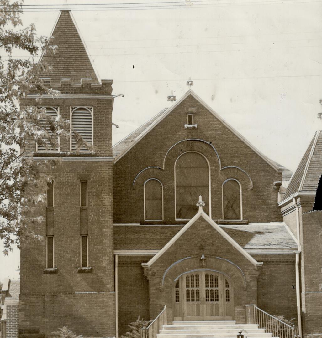 Exterior of church with tower attached left and steps leading to entrance. 