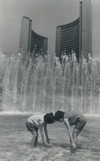 How to beat record heat, Kathy, 7, and Dena Lambron, 10, remain cool even though the thermometer climbed to 86 today in Toronto, setting a record for the year