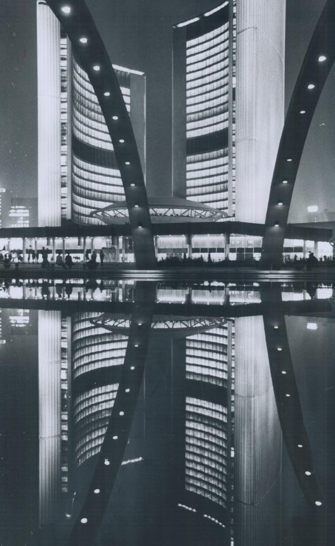 Twin towers twinned, Strollers in Nathan Phillips Square last night got an extra bonus -two city halls for the price of one