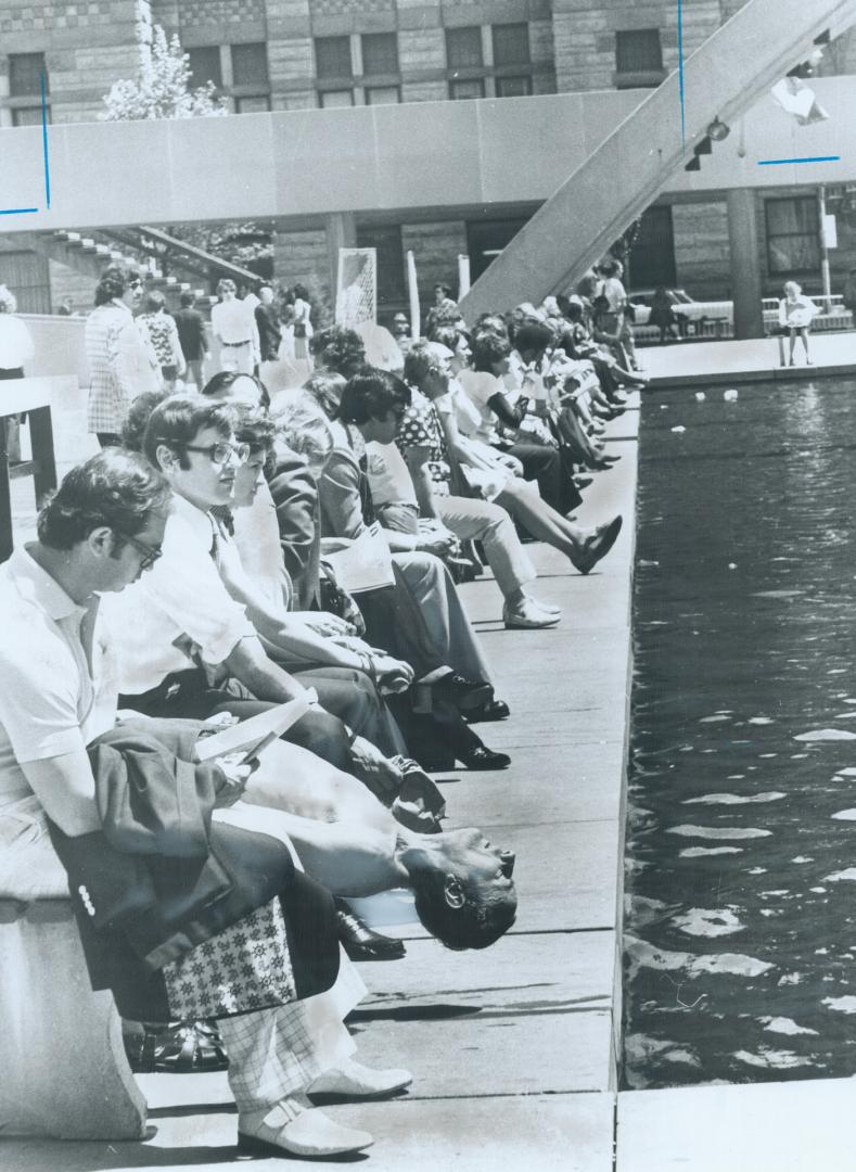 The lunch break is looking up, The reflecting pool in Nathan Phillips Square drew a lot of sun-worshippers and girl-watchers yesterday - and one man bent on fitness