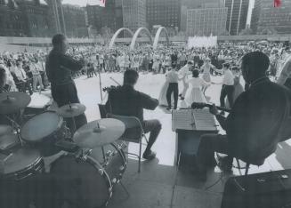 Square dancers go through their paces before an appreciate audience at Nathan Phillips Square as the Bob Scott country music group provides support. P(...)