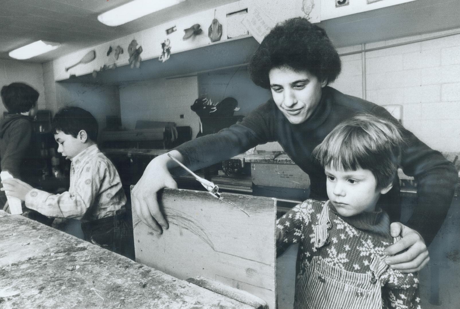 Justin Olds, 5, gets helping hand from Anthony Garafolo, 14, in club's woodworking area