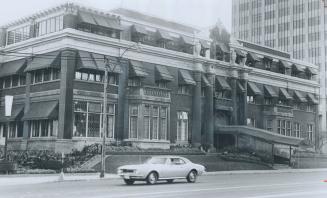 Image shows a three storey building along the street.