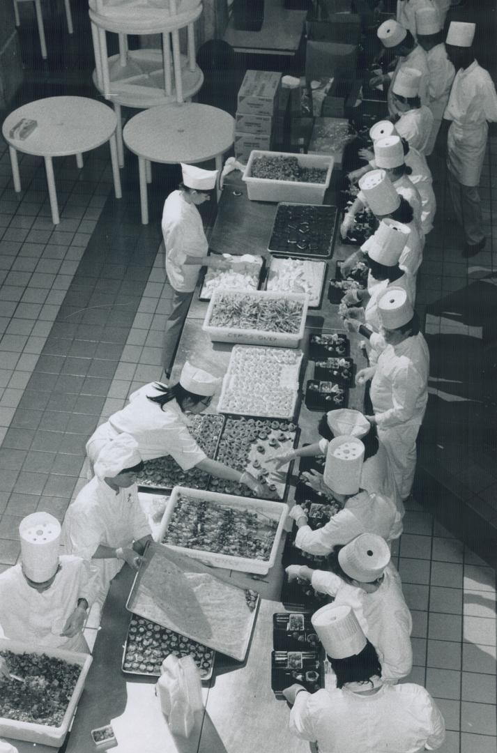 Lunches for the legions: More than 100 members of the George Brown School of Hospitality prepare 6,200 box lunches for guests at tonight's SkyDome opening