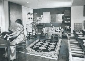 Luxurious interior of CNE prize house is exemplified in this picture of the living room taken from the entry at the kitchen end. Debbie Griffin is at (...)