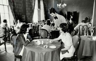 Twenty-One McGill street manager, Isabel Beveridge left, and assistant Susan Woodroofe enjoy lunch in the dining room of the new women's club. The clu(...)