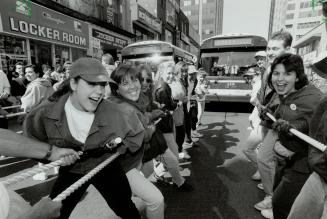 Pulling for a good cause, Humber College students pull two buses down Yonge St