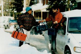 Faithful volunteers: Bibi Mearns, left, and Shirley Chang deliver Meals on Wheels in all kinds of weather for the Woodgreen Centre