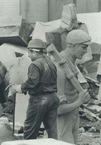 Workmen, real and stone: The eight huge figures outside the Electrical Building, just inside the Princes' Gates at the Canadian National Exhibition