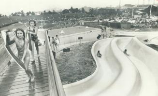 Newest toy at Ontario place, the 370-foot long, $400,000 water slide attracted mostly youngsters when it opened officially yesterday, and it was a rac(...)