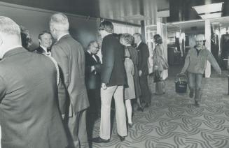 Premier and a Pail-Carrier work together, While Ontario Premier William Davis (facing camera at left) shakes hands with dignitaries at a preview recep(...)