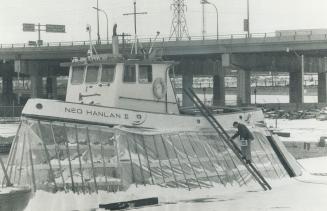 Wearing a plastic skirt, the Toronto Island tug Ned Hanlan sits high and dry undergoing winter maintenance work at drydock on Queen's Quay. The screen(...)