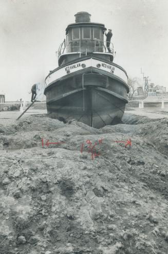 Old Ned--grounded, Moored in its new drydock home at the Canadian National Exhibition where it will be on permanent display, the ferry boat-tug Ned Hanlan is getting a brand new paint job