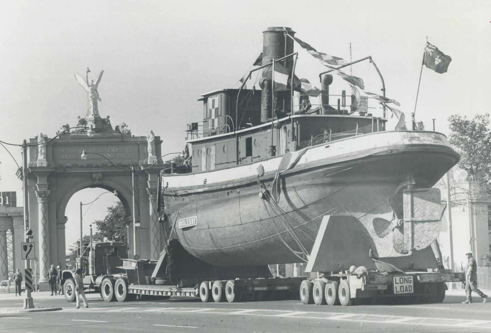 The Ned Hanlan 'Cruises' along lake shore, On its final cruise, the Toronto Harbor steam tug Ned Hanlan is towed along Lake Shore Blvd. past the Princ(...)