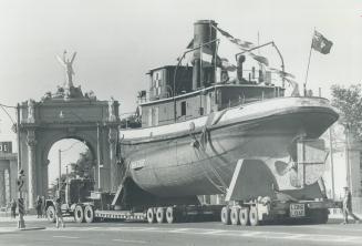 The Ned Hanlan 'Cruises' along lake shore, On its final cruise, the Toronto Harbor steam tug Ned Hanlan is towed along Lake Shore Blvd. past the Princ(...)