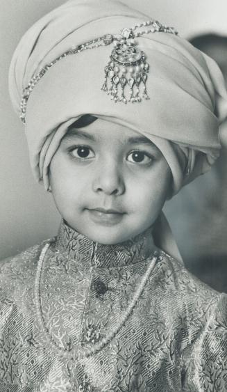 Solemn moment in the life of 4-year-old Farhan Sayeed as he takes part in the Moslem ceremony of Bismillah on Saturday to mark the beginning of his fo(...)