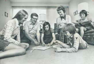 French version of scrabble occupies Andre and Rita Ouellette and their family on the floor of living room