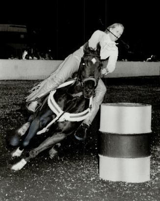 Roll past the barrel: That's what Virginnia Reynolds is trying to do in the ladies' barrel race at the annual CNE Horse Show