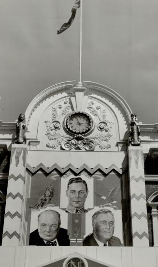 Three great leaders appear in portraits in front of the Administration building, with King George VI in the middle and Roosevelt and Churchill on eith(...)