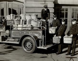 Firemen distribute cheer to Toronto hostels