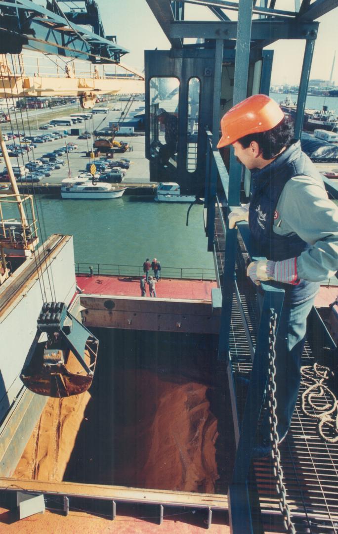 Image shows a worker on board watching unload in progress.