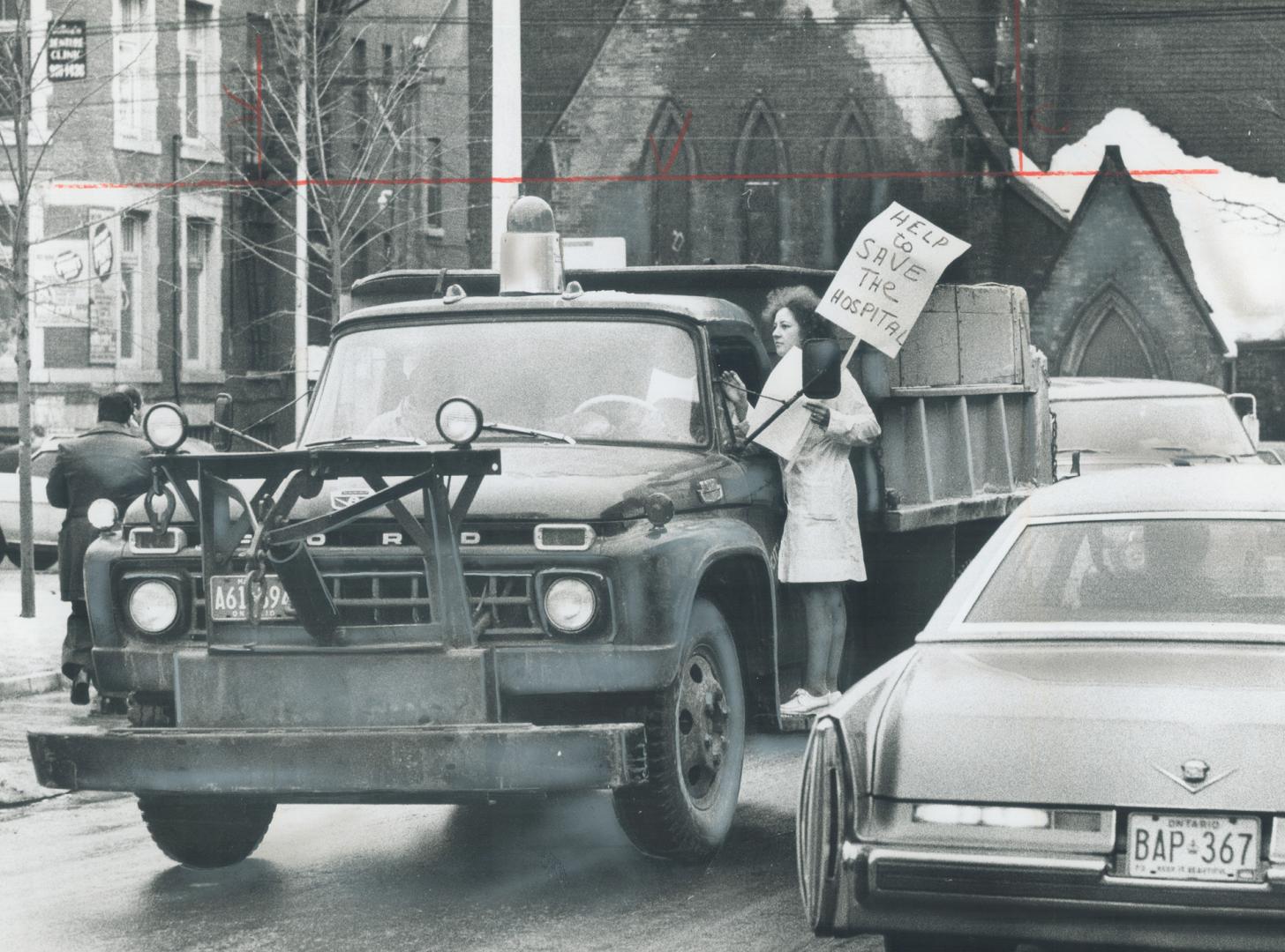 Getting signatures on a petition urging that Doctors Hospital be kept open, Clara Wall, a cashier in the hospital cafeteria, gets up on a truck runnin(...)