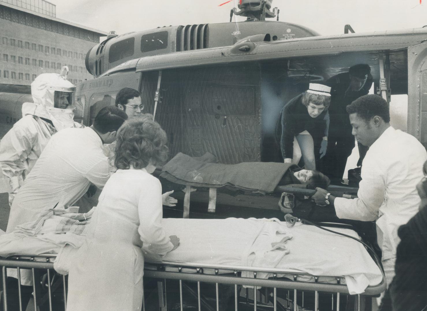 Lifted from helicopter after landing on hospital roof, the 7-year-old patient, Steven Rosenitsch was carried on stretcher by orderlines