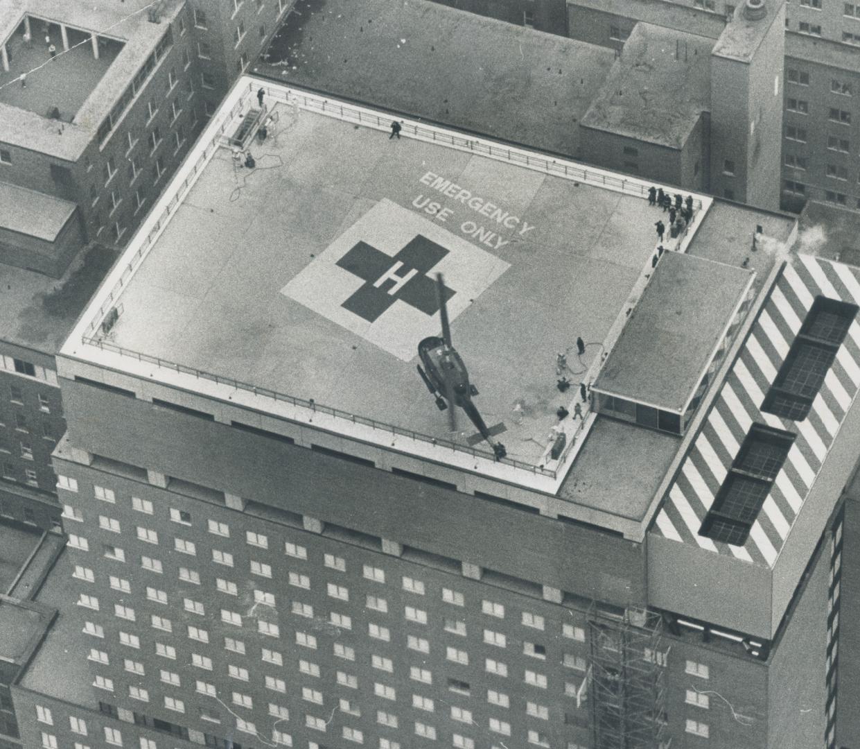 Hospital heliport atop the Toronto Hospital Sick Children gets its first test today as a angle-rotor Canadian Forces helicopter drops onto the 120-by-(...)