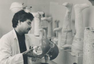 Sandy Robinson inspects a freshly formed child's helmet at the Hugh MacMillian Medical Centre, where more than 2,000 patients a year are fitted with artificial limbs, braces and protective head gear