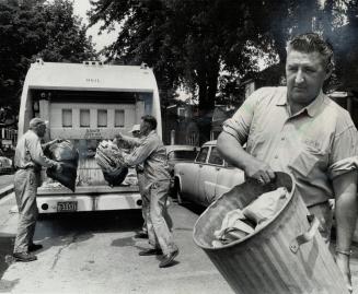 Ed Lorimer (foreground) says there isn't much poetry in a garbage man's life