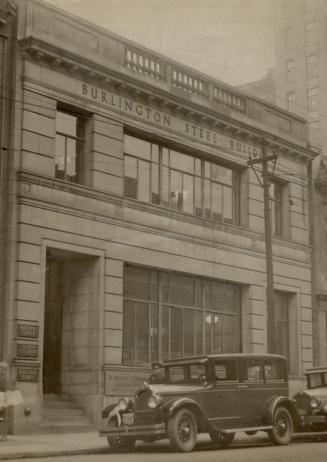 Façade of two-storey building with the words Burlington Steel Building above second floor windo…