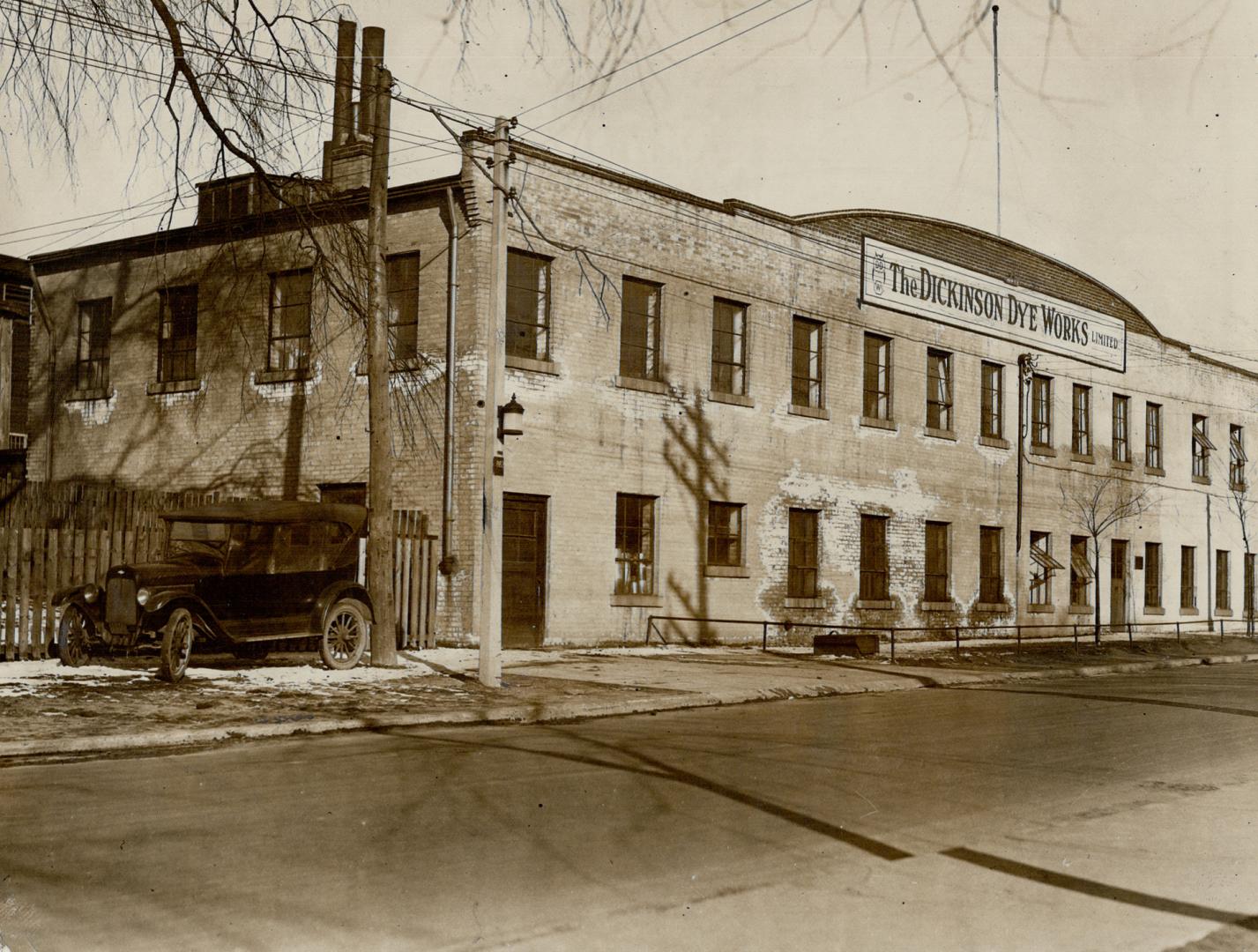 Façade of two-storey brick building with large sign displayed below roofline reading, The Dicki ...