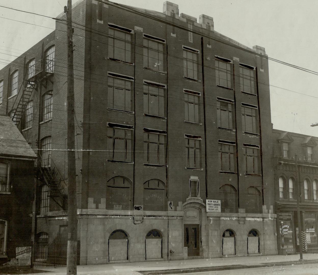 Exterior view of five-storey brick building.