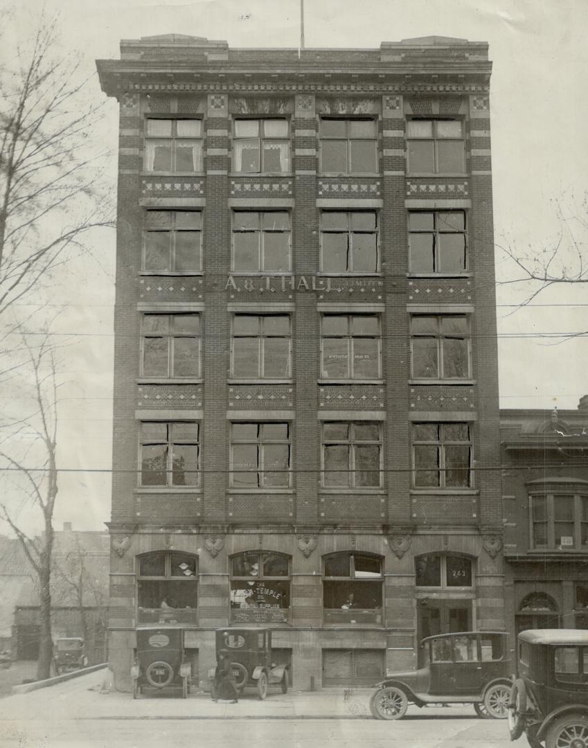 Façade of five-storey brick building.