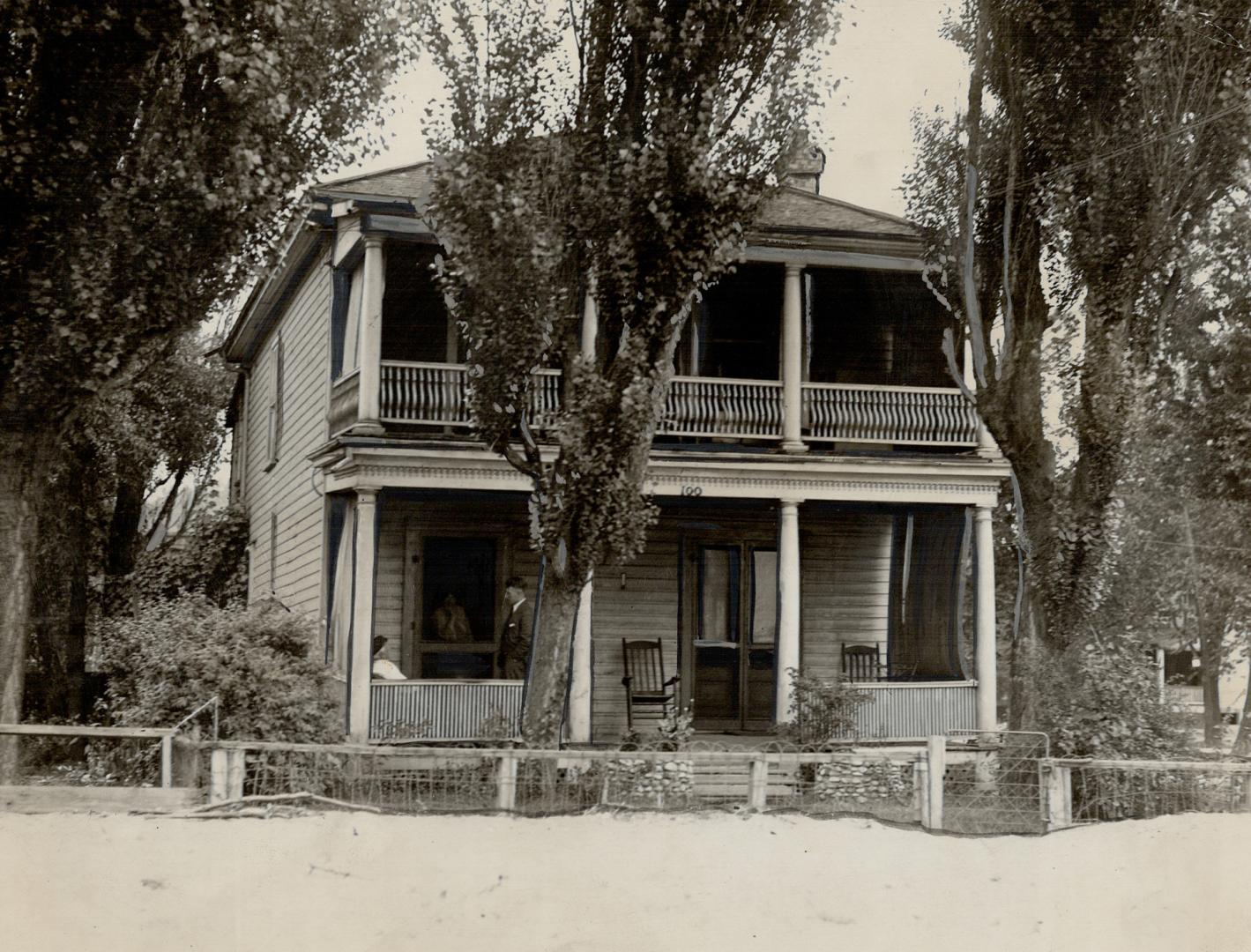 Two-storey clapboard structure with covered porches first and second floor.