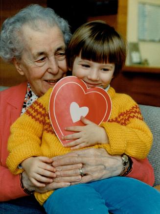 Kipling Acres home for the Aged resident Mary Metclafe, 87, is smiling because a shylooking Marianna Kirezov, 3, is about to hand over a special valen(...)