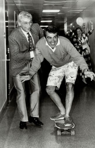 Hospital fund on a roll. Hospital for Sick Children president David Martin (left) lends a helping hand as Dr. Douglas Johnston clowns it up on a skate(...)