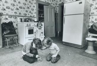 Water overflowing upstairs made the hole in the ceiling 6-year-old Donald Moore points to while his little brother, Stephen, 5, plays on the cockroach(...)