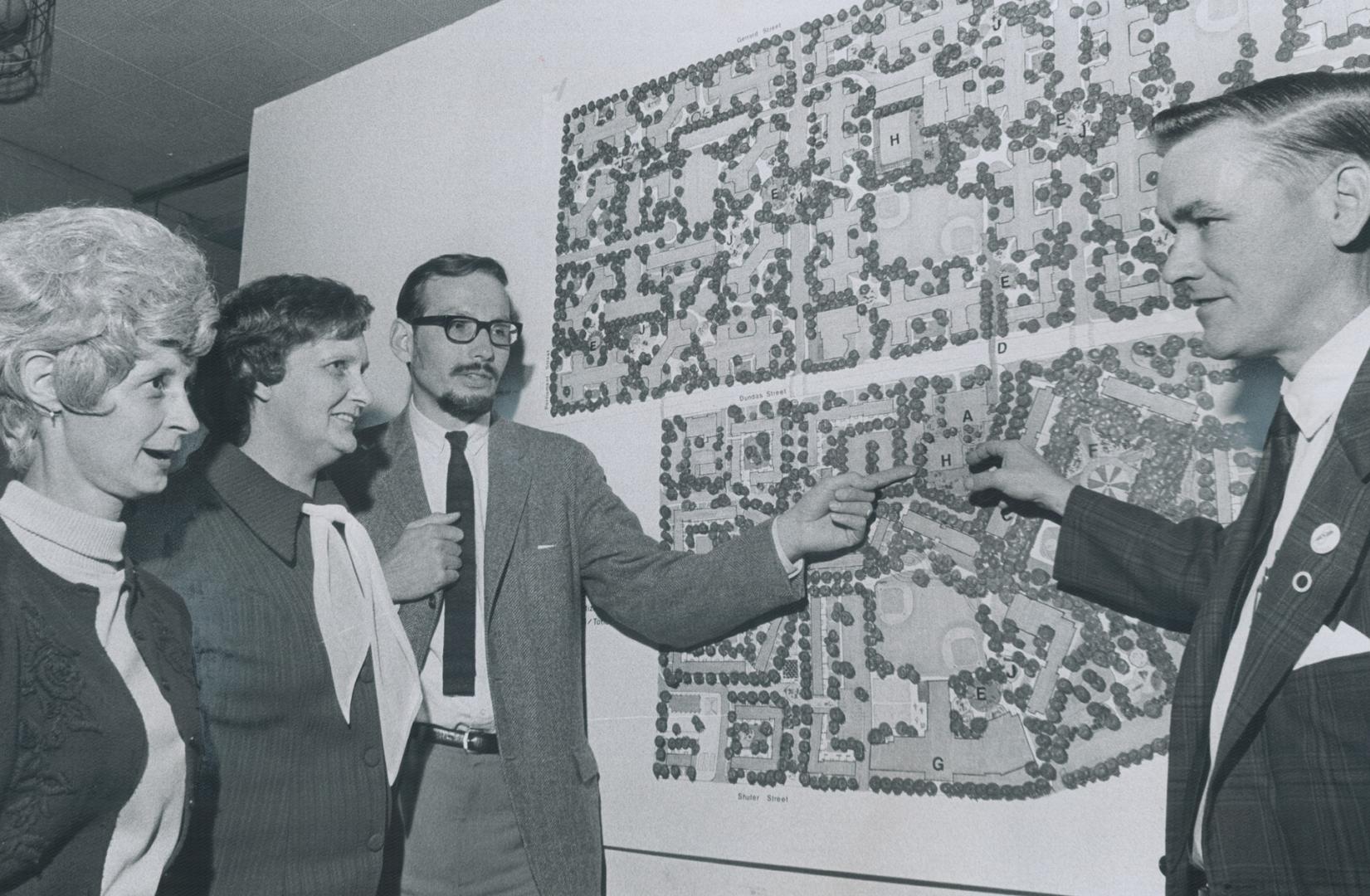 Examining regent park plan to turn paved playgrounds and several parkland, and build a community centre and swimming pool, Mrs. Betty Strand (left) an(...)