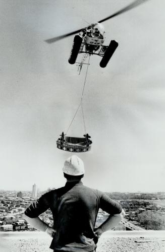 A crown for a prince. Topping off ceremonies at the Prince Hotel on Don Mills Rd. featured the lowering by helicopter of a huge crown onto the roof of(...)