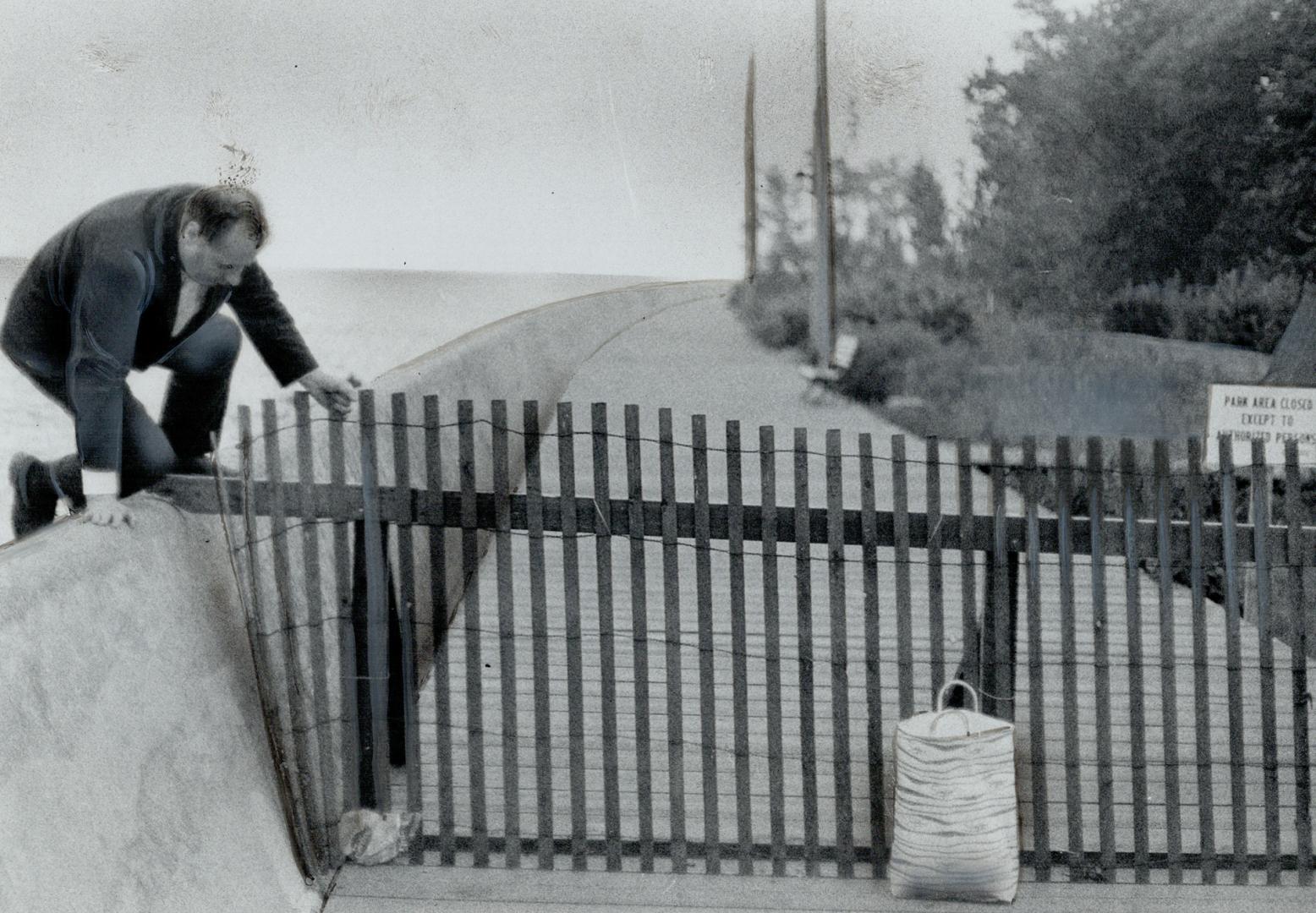 It's like the Berlin Wall, a Ward's Island resident says of the reinforced snowfence barricades that now block the boardwalk in front of several houses